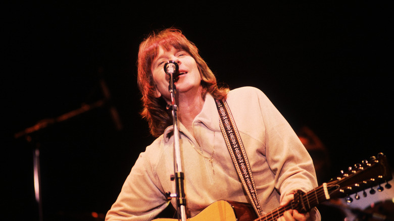 Randy Meisner playing guitar singing leaning