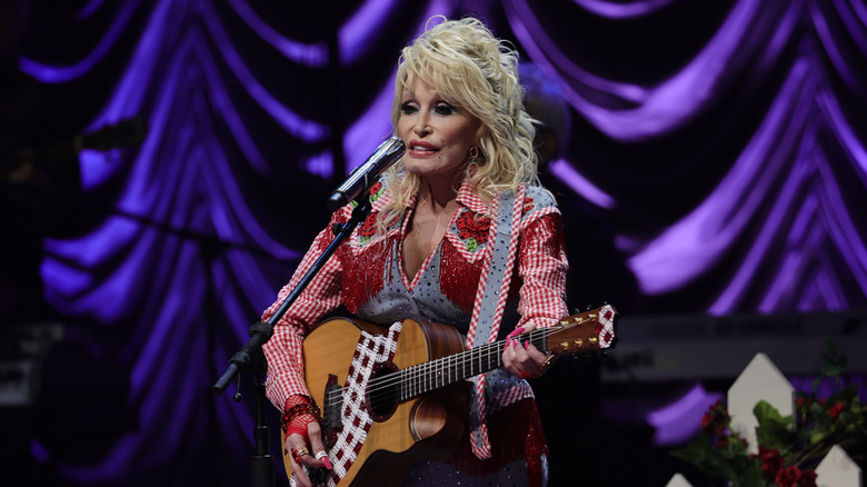 Dolly Parton playing guitar