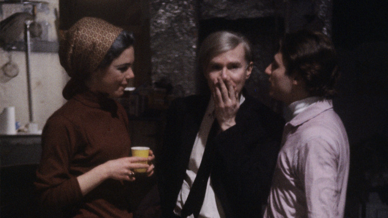 Edie Sedgwick standing with Andy Warhol