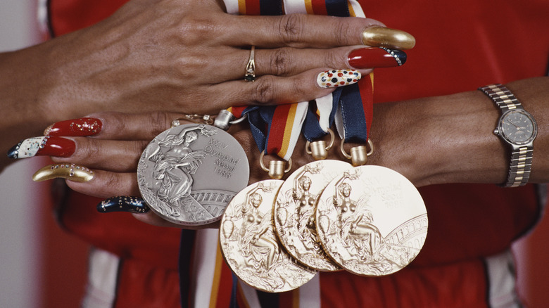 Florence Griffith Joyner displaying Olympic medals
