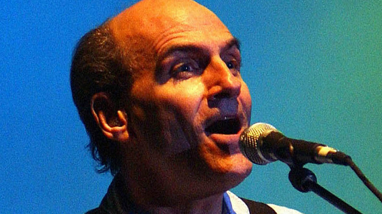 James Taylor singing and playing guitar