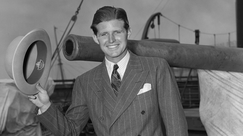 Joseph Kennedy Jr. waving hat boat
