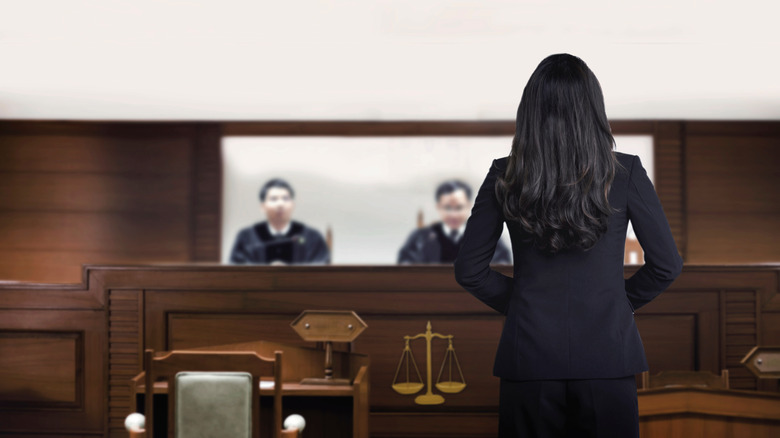 Woman addressing judges at court