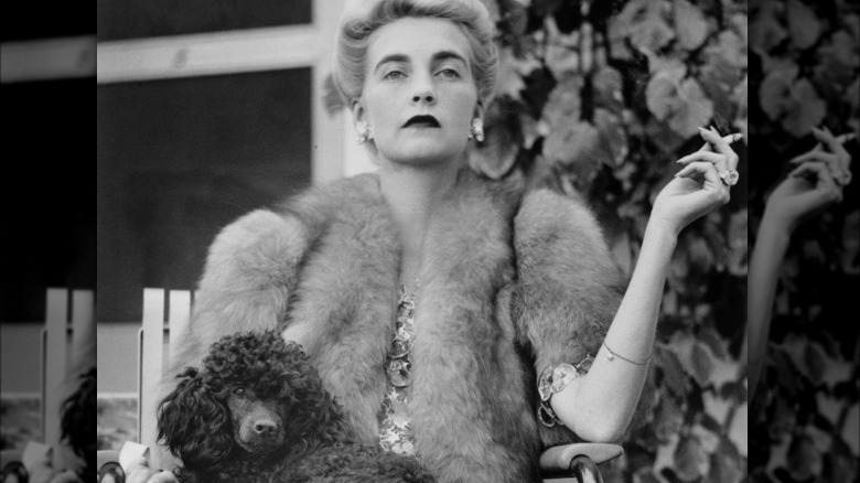 Barbara Hutton holding a poodle