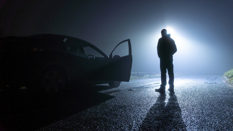 person and car in shadow