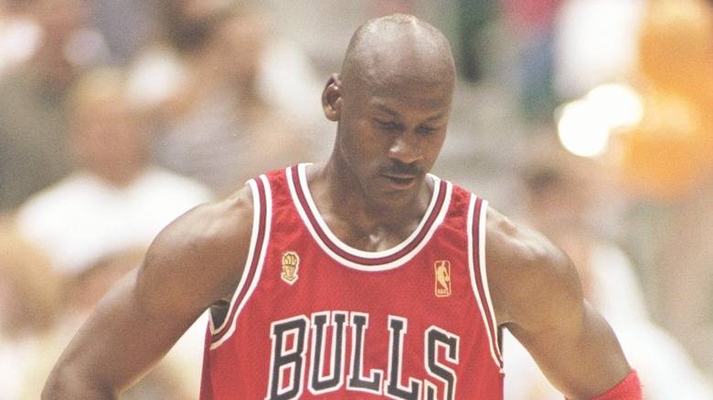 Chicago Bulls player Michael Jordan looking down