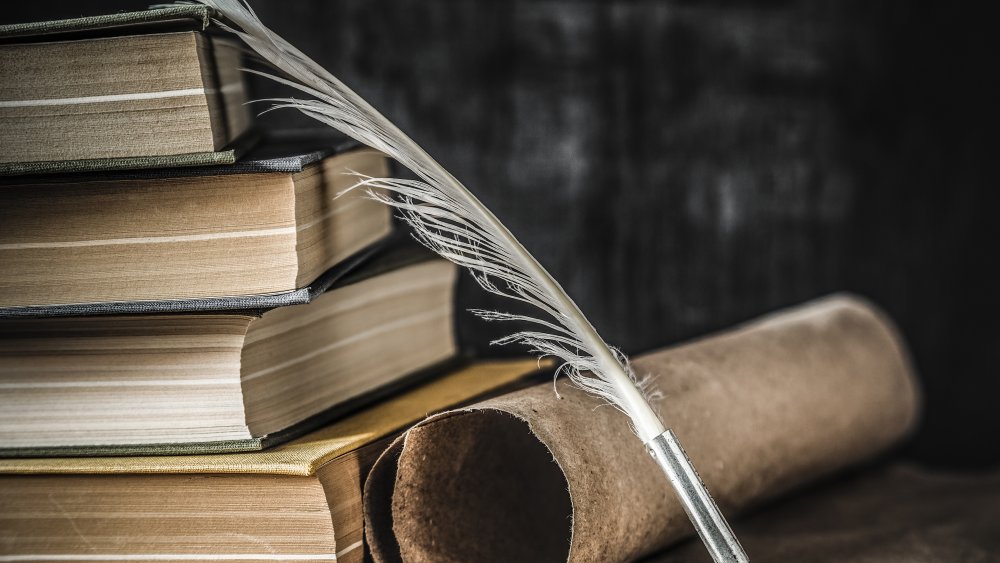 Quill, books, and paper