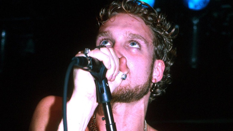 Layne Staley singing shirtless and looking upward