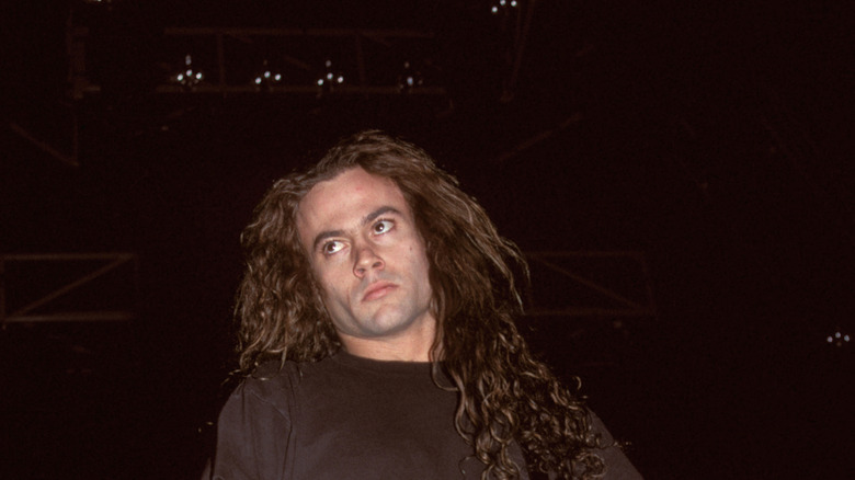 Mike Starr playing bass and looking up