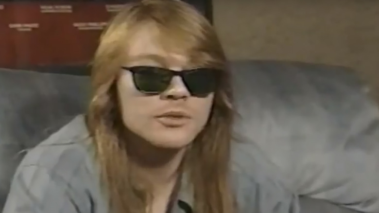 Young Axl Rose sunglasses sat sofa