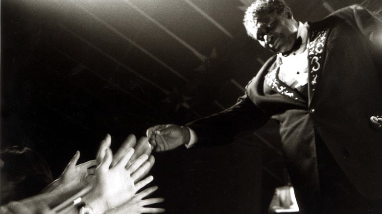B.B. King extending arm into crowd at concert