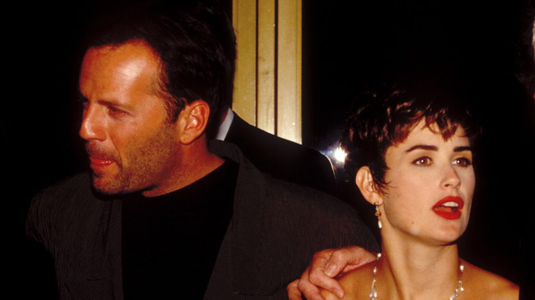 Demi Moore and Bruce Willis looking opposite directions