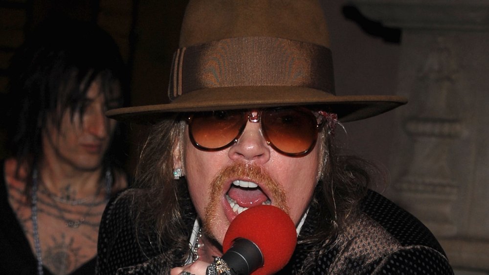 Axl Rose wearing hat and sunglasses