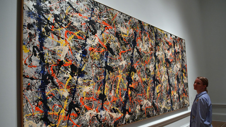 Woman looking at Jackson Pollock painting