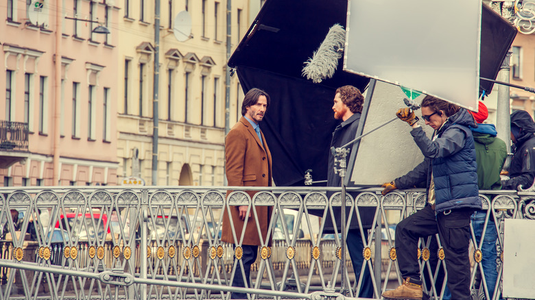 keanu reeves on a movie set bridge with lights