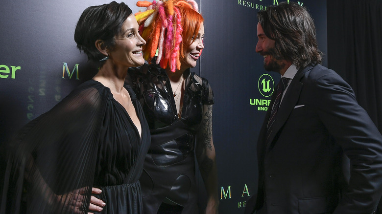 keanu reeves, carrie anne moss, lana wachowski smiling
