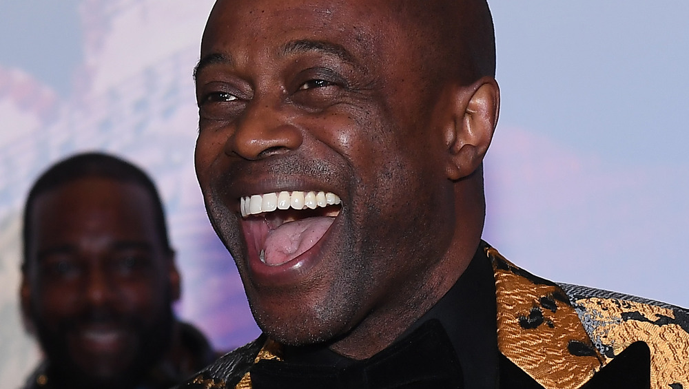 Kem laughs onstage in 2019