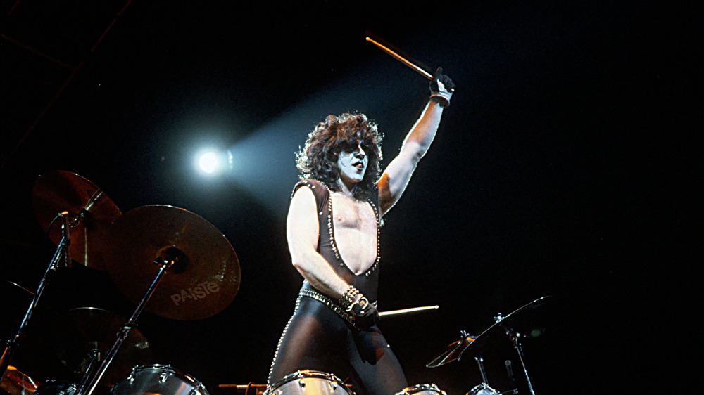 drummer Eric Carr with drumsticks in air