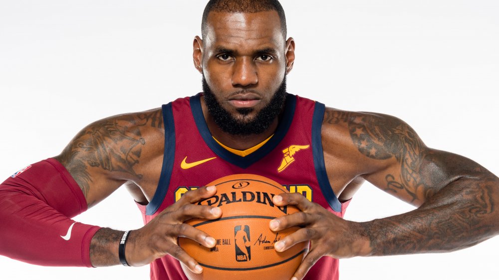 LeBron James holding basketball white background