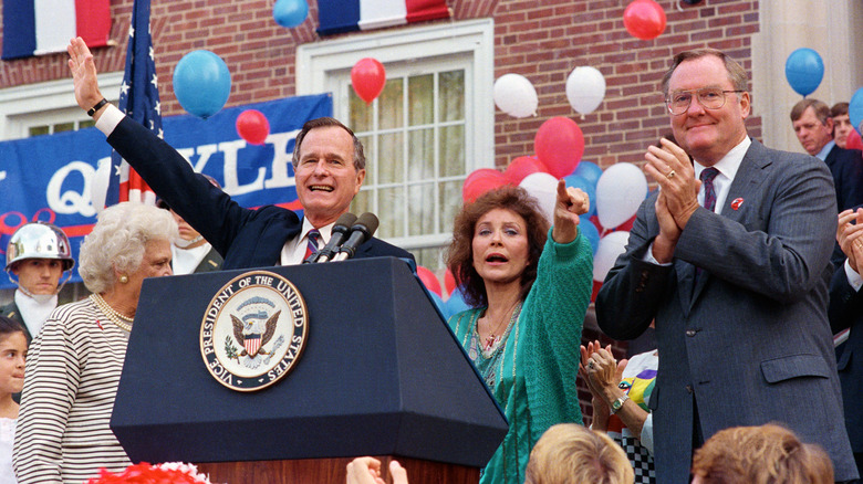 loretta lynn and george h w bush at podium arms raised