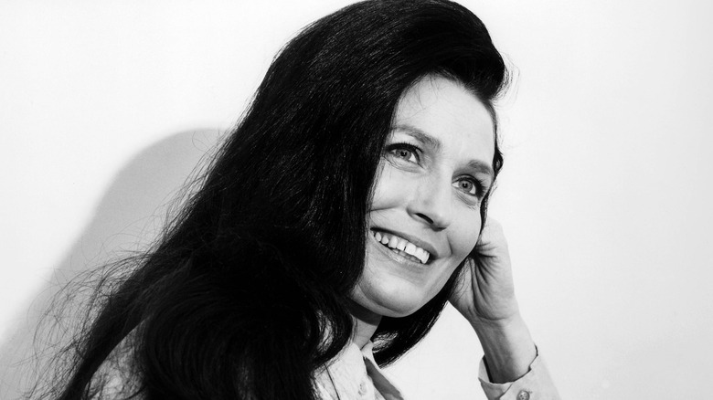 Loretta Lynn smiling with head on hand white background