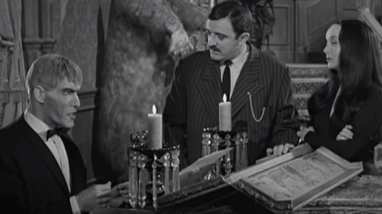 lurch gomez morticia the addams family around the piano