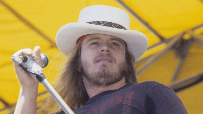 Ronnie Van Zant holding mic