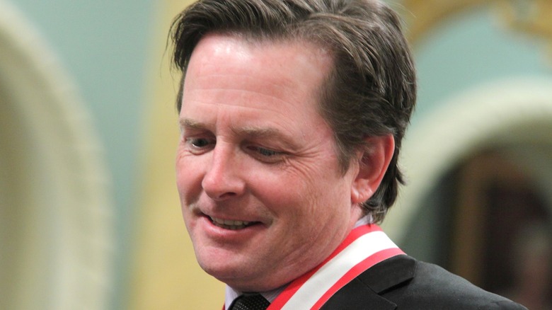 Michael J. Fox with a medal