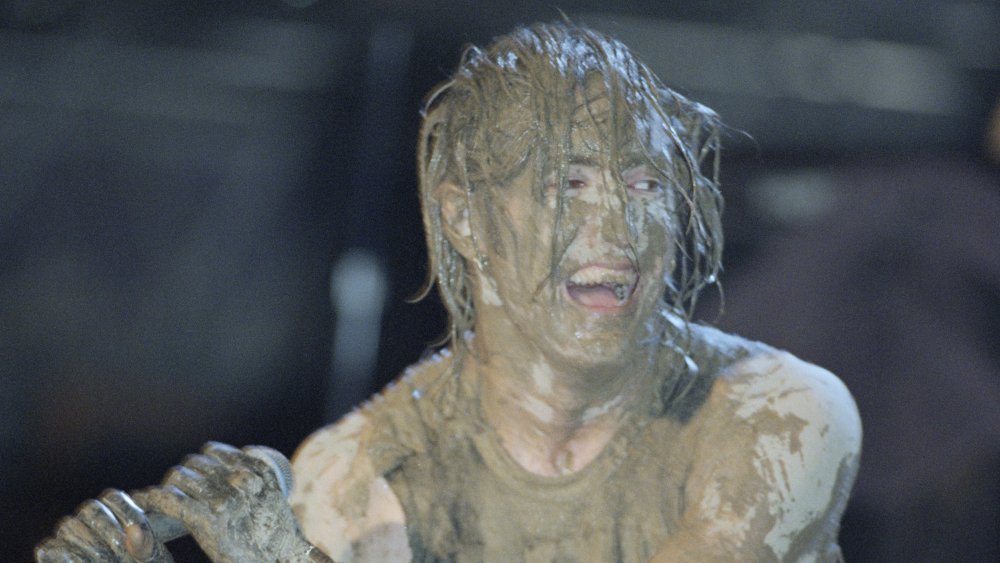 Trent Reznor covered in mud