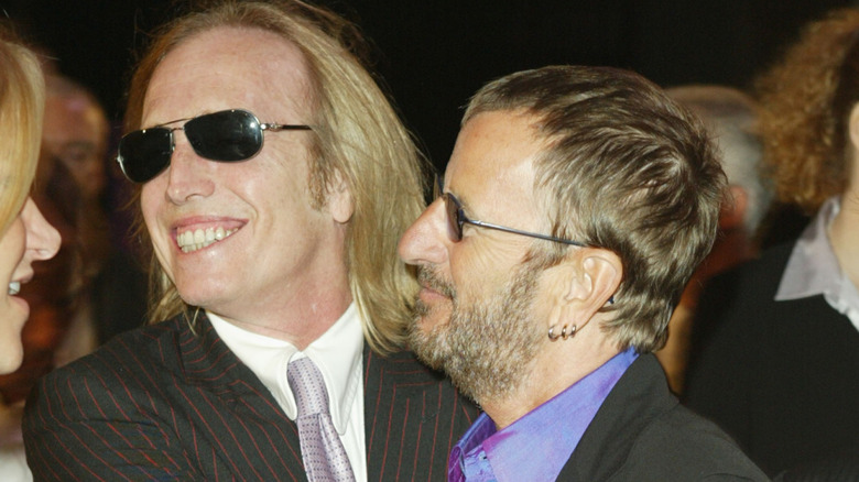 Tom Petty and Ringo Starr hugging and smiling