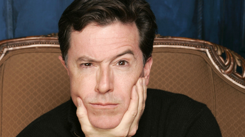 Stephen Colbert cradling his chin in his hand