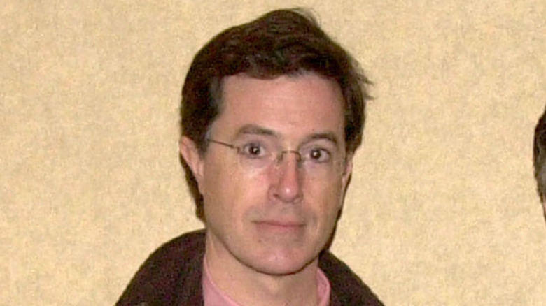 Stephen Colbert photographed in front of a beige background