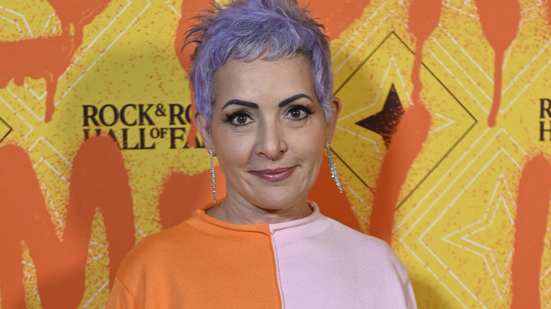 Jane Wiedlin smirking and Rock and Roll Hall of Fame event
