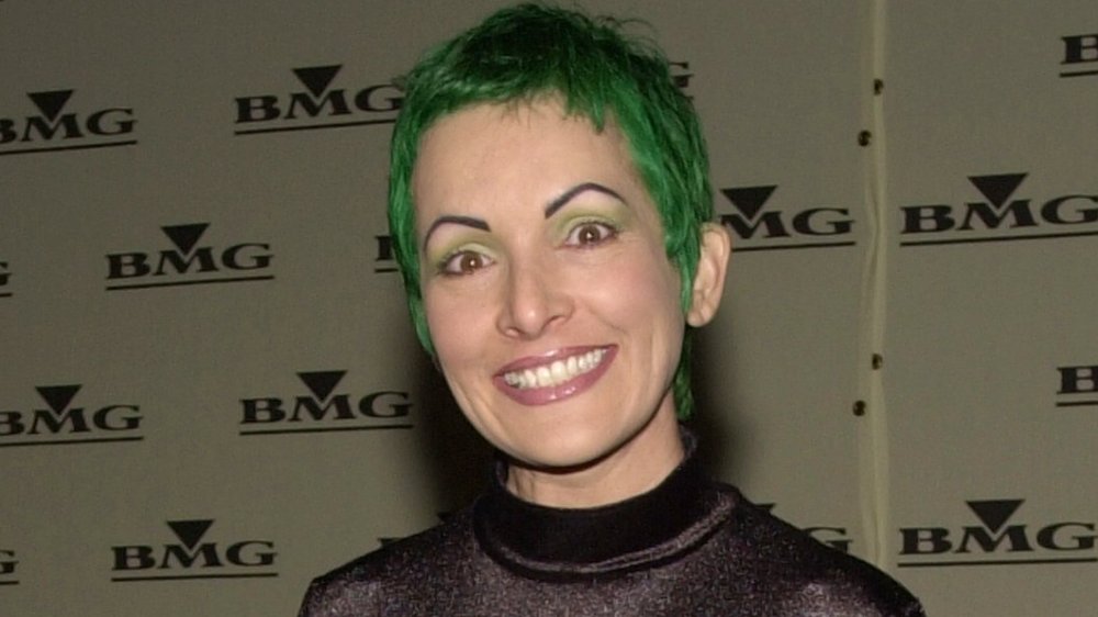 Jane Wiedlin smiling with short green hair at event