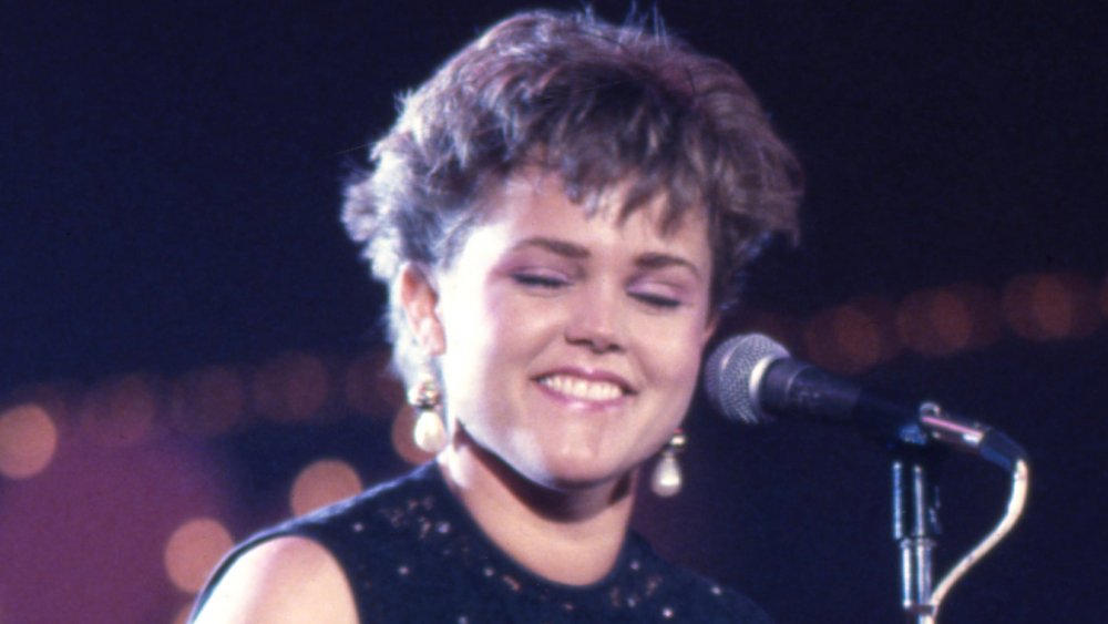 Belinda Carlisle smiling by mic on stage