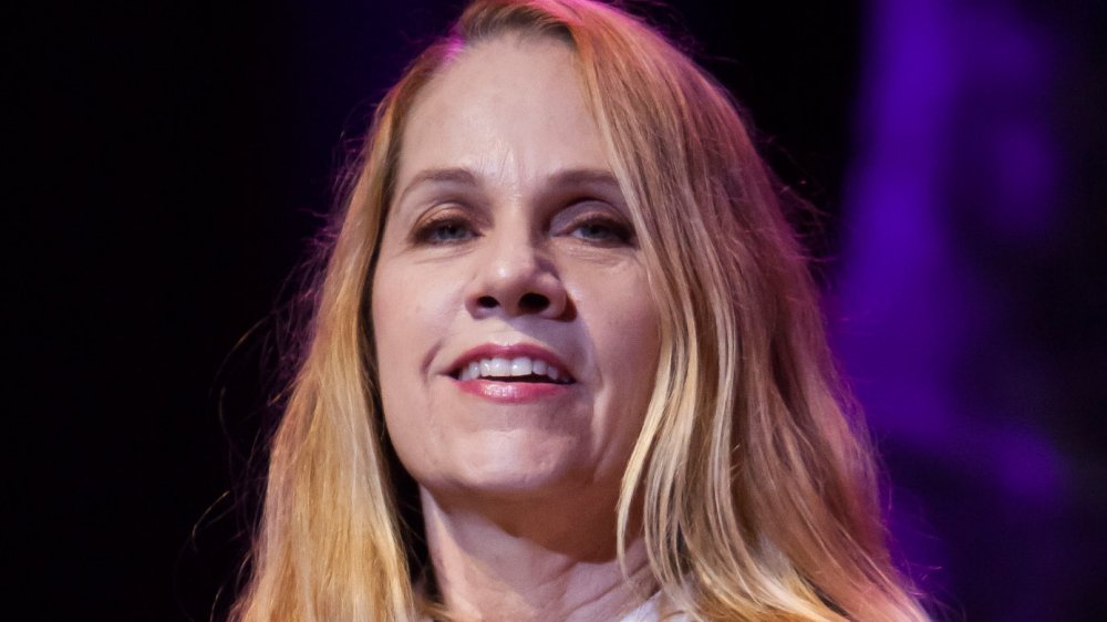 Charlotte Caffey smiling on stage at event
