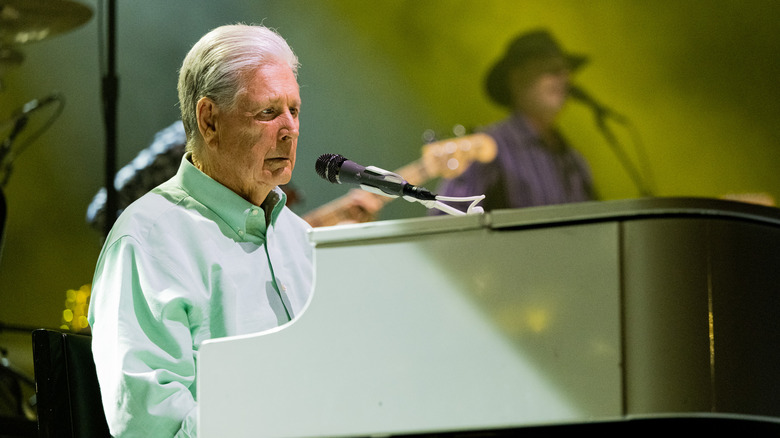 Brian Wilson in white shirt at white piano