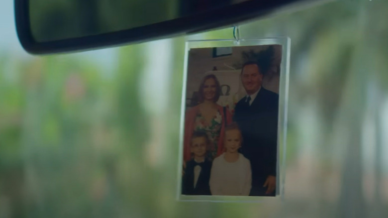 Family picture hangs from car mirror