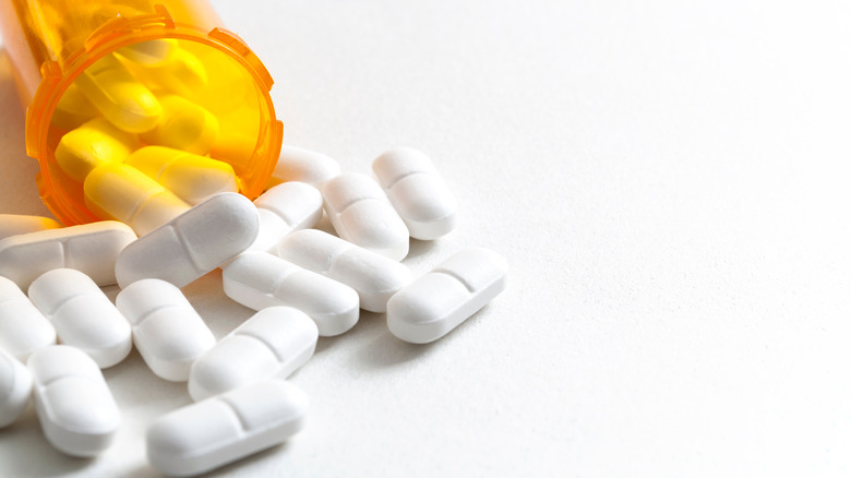 prescription pill bottle and white pills