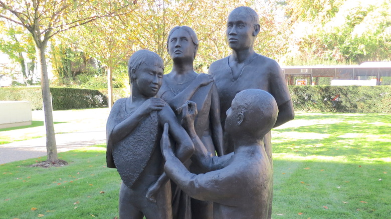 Smallpox vaccination, statue outside the WHO HQ entrance Geneva