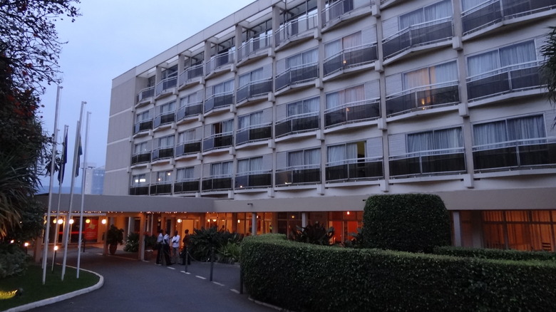 entrance Hôtel des Mille Collines driveway and staff