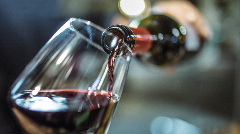 red wine bottle poured into glass