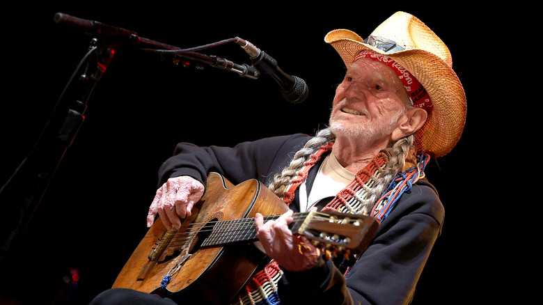 Willie Nelson playing guitar