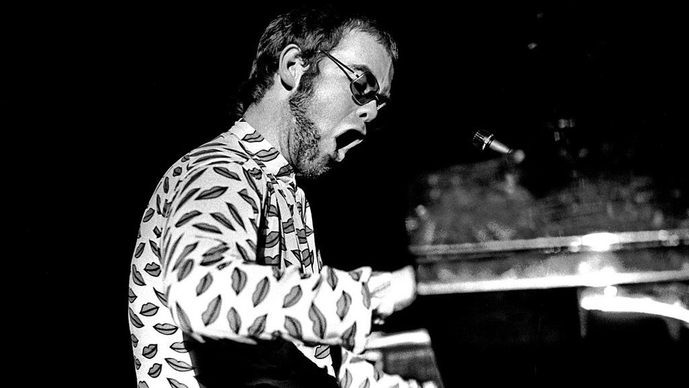 Elton John performing in concert