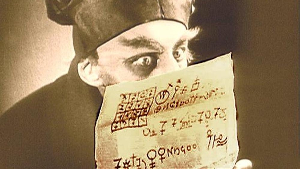 Nosferatu reading a letter full of hermetic symbols