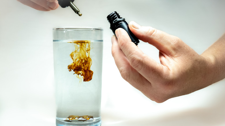 Drop of colloidal silver in water glass