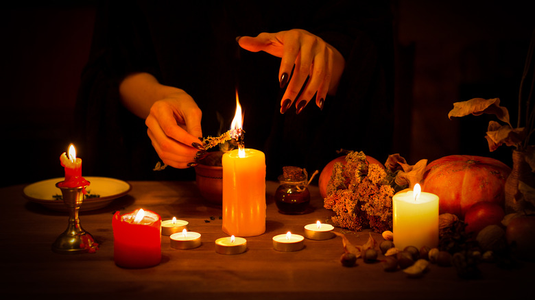 hands lighting candles