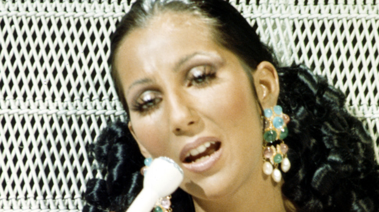 Cher singing into a microphone, 1974
