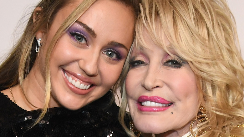 Miley Cyrus and Dolly Parton smiling