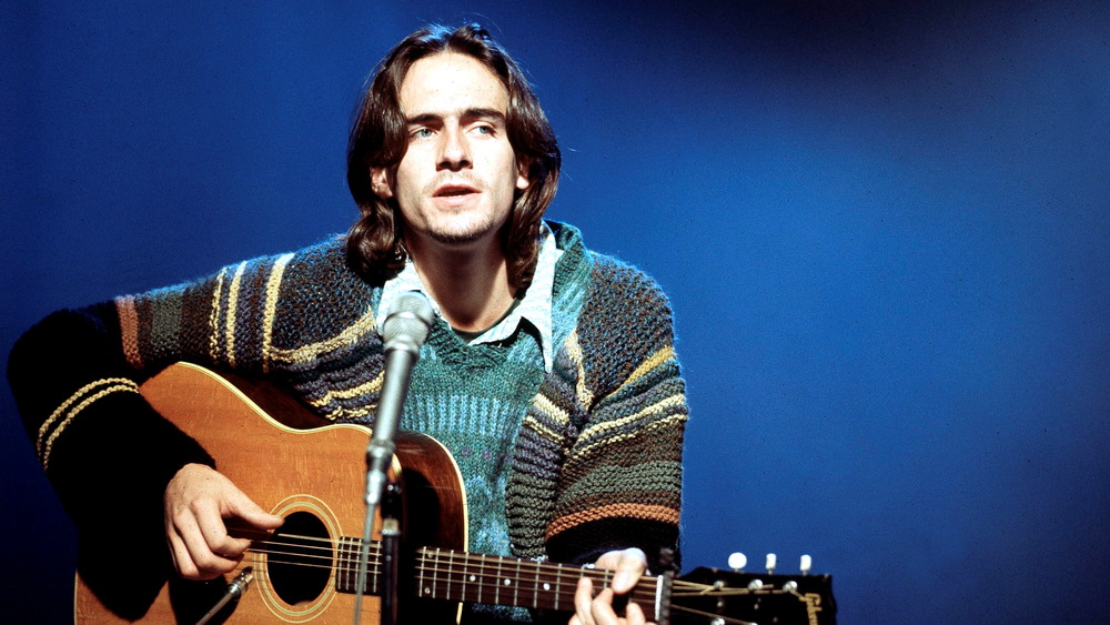 Long-haired James Taylor on stage in 1971